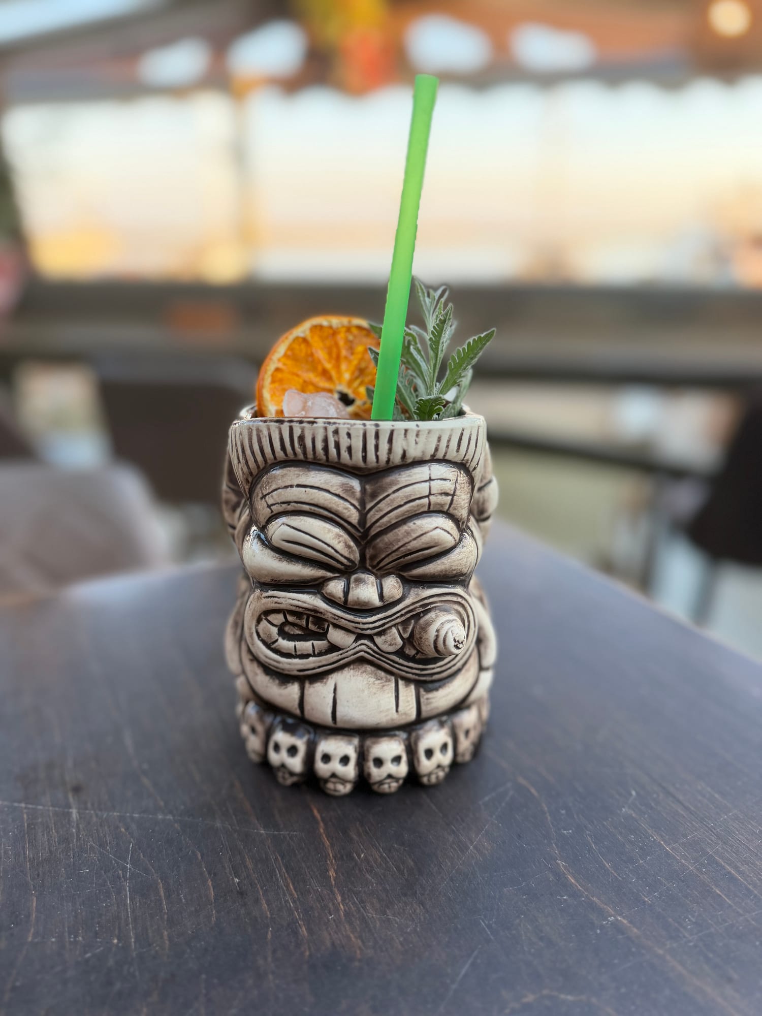 Skull-shaped tiki mug with a green straw
